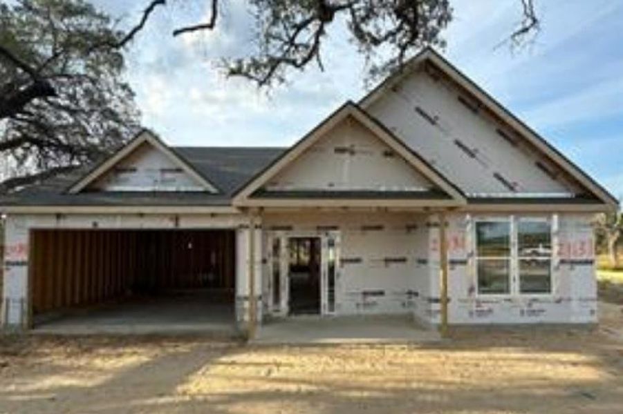 Property in mid-construction with a covered front porch Property in mid-construction with a covered front porch