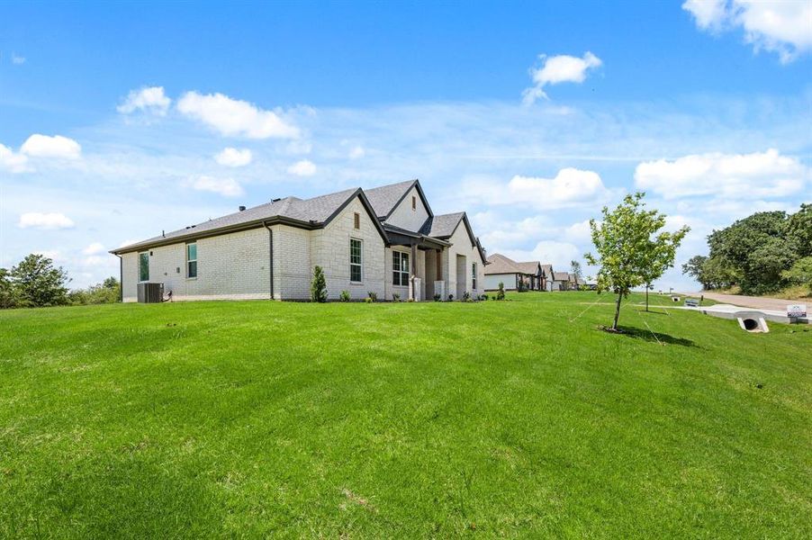 Front exterior of a new home in Saddleback Estates, Boyd, TX, highlighting curb appeal (Image 20).