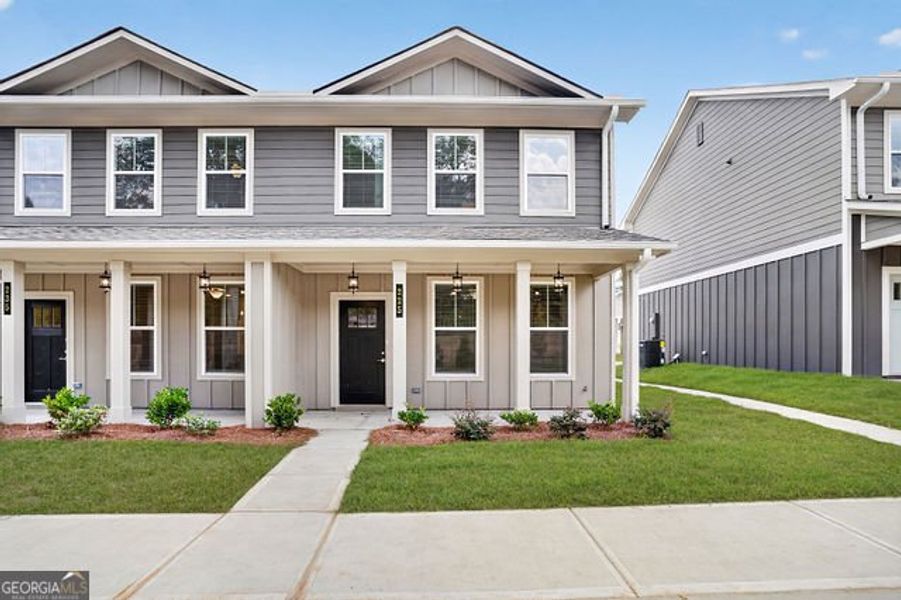 Front exterior of a new home in The Cottages at East Lanier, Fayetteville, GA, highlighting curb appeal (Image 1). Front exterior of a new home in The Cottages at East Lanier, Fayetteville, GA, highlighting curb appeal (Image 1).