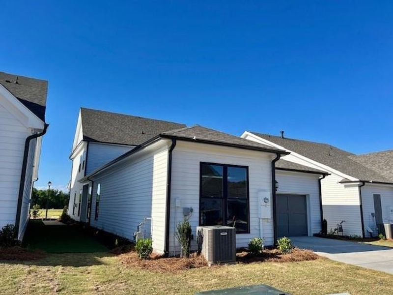 Front exterior of a new home in Promenade at Sawnee Village, Cumming, GA, highlighting curb appeal (Image 2).