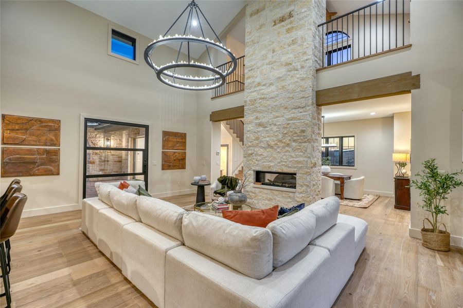 Gorgeous family room with 2-story, double-sided rock fireplace & beautiful hardwood floors.