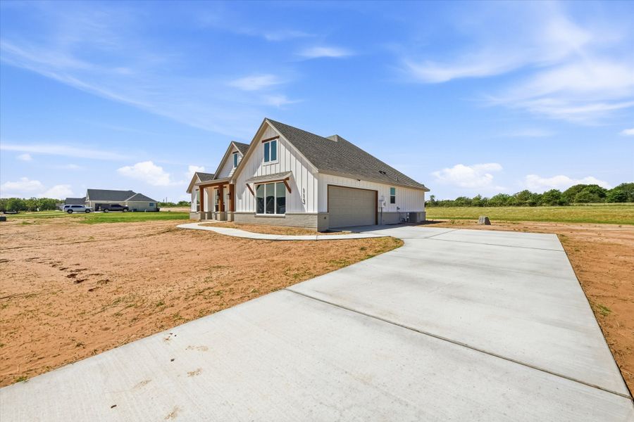 Front exterior of a new home in Zion Valley, Poolville, TX, highlighting curb appeal (Image 17).