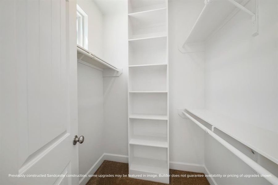 Walk-In Closet for Secondary Bedroom – Custom shelving and generous space make this walk-in closet a dream for organization.