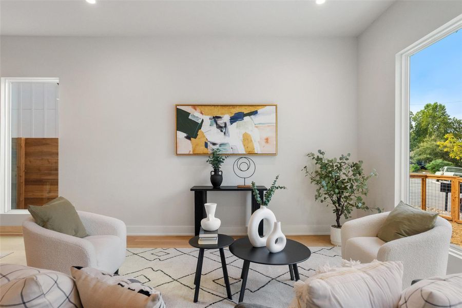 Living area featuring wood finished floors and recessed lighting Living area featuring wood finished floors and recessed lighting
