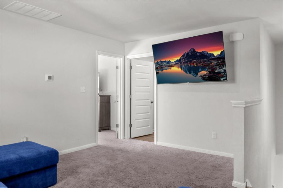 Sitting room featuring carpet flooring and baseboards