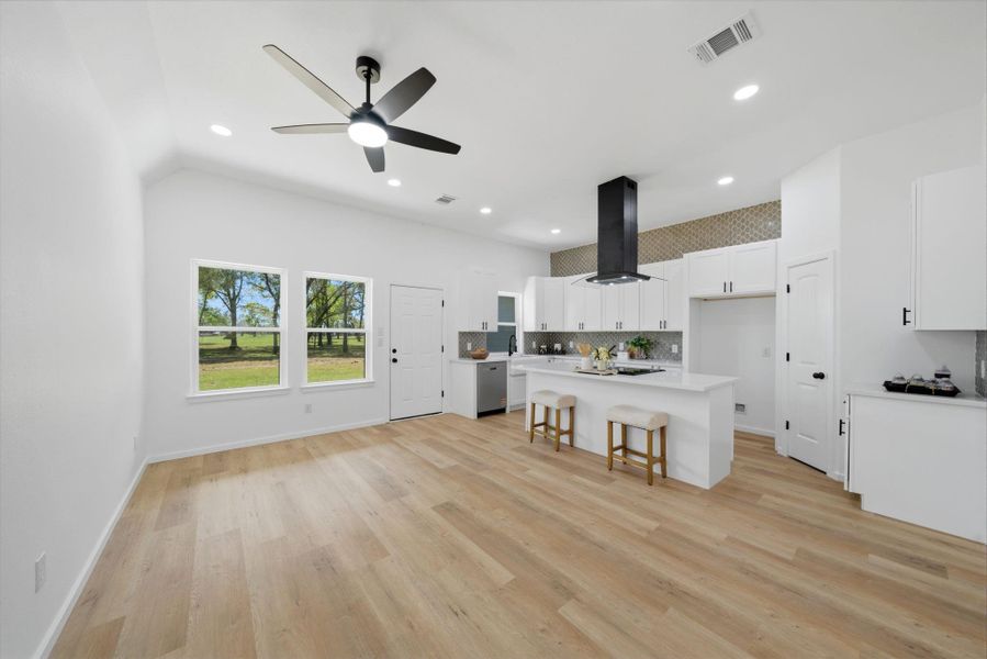 Experience the modern elegance of this open-concept kitchen and living area, where bright, open spaces create a welcoming and contemporary atmosphere. The design seamlessly blends style and functionality, perfect for both family gatherings and entertaining.