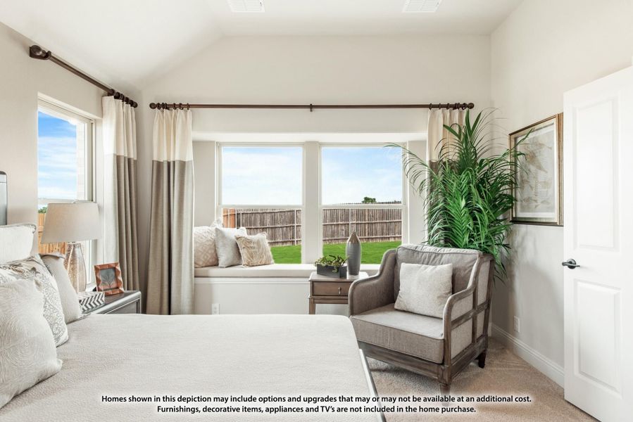 Bedroom with vaulted ceiling, bay window seat, neutral decor, and backyard view