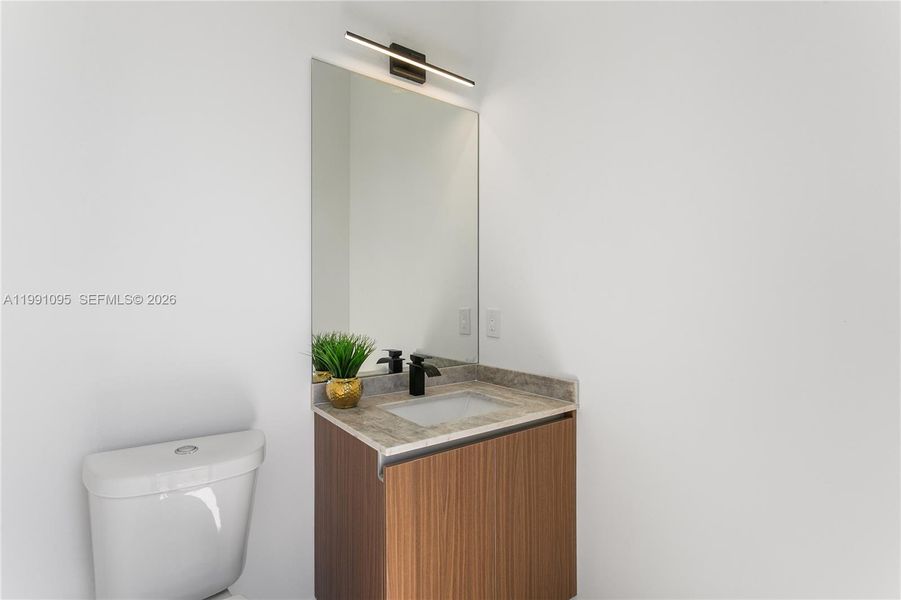 Convenient cabana half bathroom provides easy access from the pool area, perfect for guests and outdoor entertaining. Convenient cabana half bathroom provides easy access from the pool area, perfect for guests and outdoor entertaining.