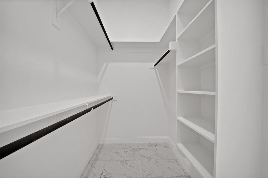 Spacious closet with light marble finish flooring