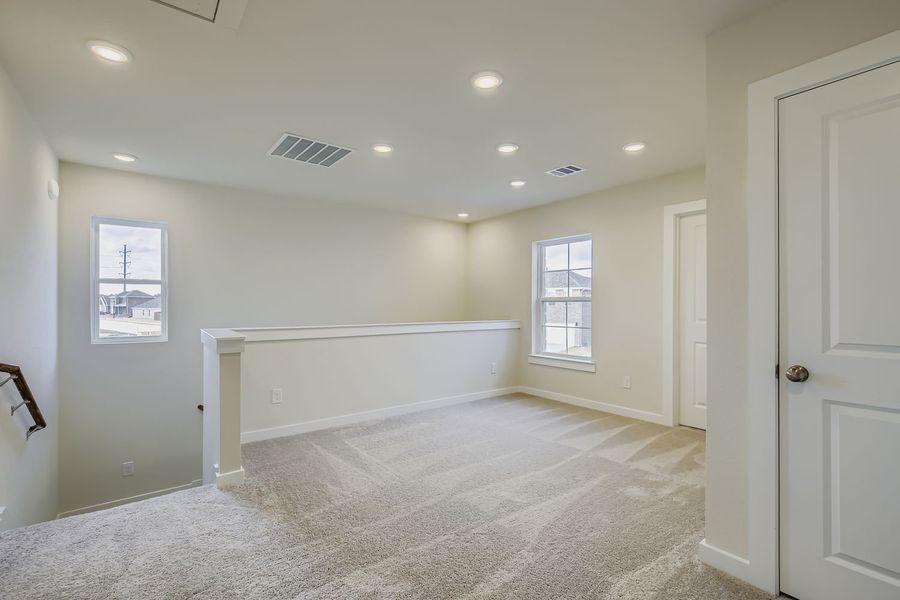 A room with white walls and a white bench.