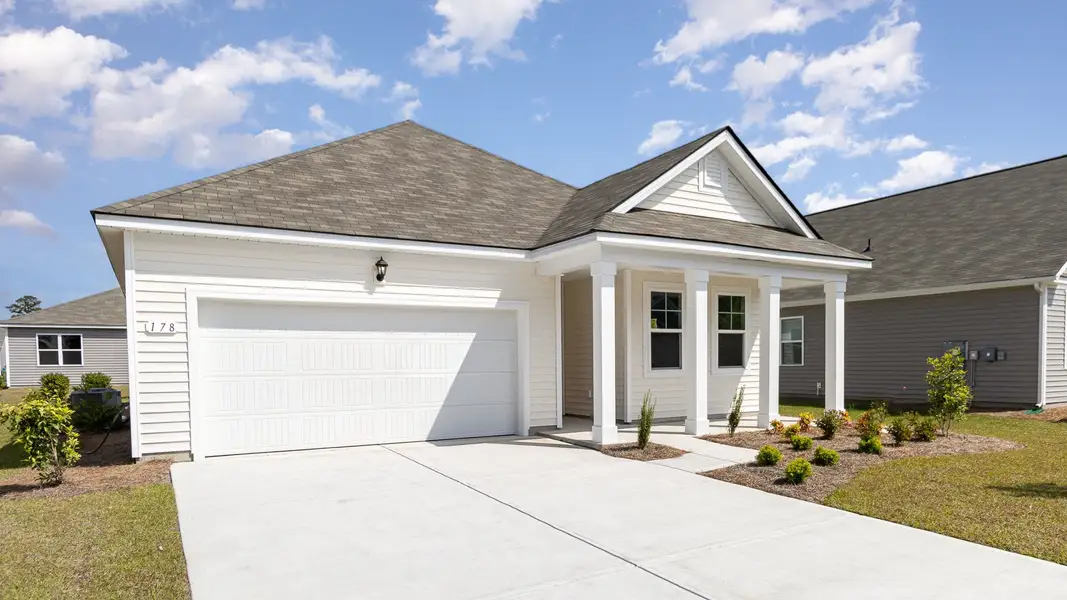 Front exterior of a new home in Pinewood Estates, Conway, SC, highlighting curb appeal (Image 2).