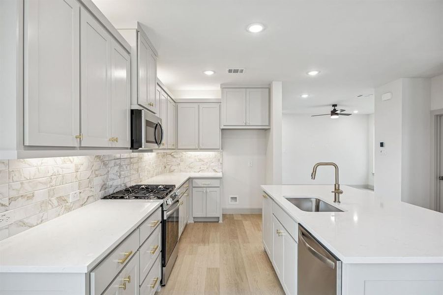 Beautiful cabinetry, gorgeous counter tops and designer backsplash effortlessly pair with contemporary stainless steel to create a kitchen for the ages!