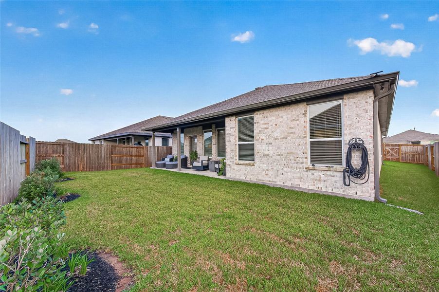 Spacious fenced backyard with plenty of lawn space. Spacious fenced backyard with plenty of lawn space.