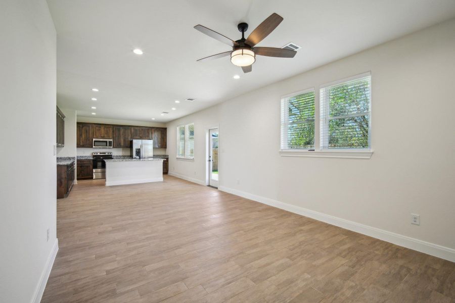 Living Area featuring baseboards, visible vents, and light wood-type flooring Living Area featuring baseboards, visible vents, and light wood-type flooring