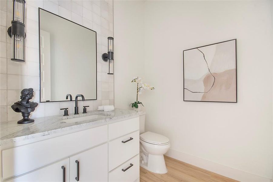Half bath with vanity and light wood-style floors Half bath with vanity and light wood-style floors