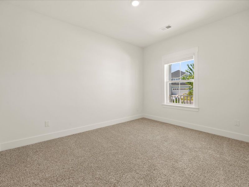 Spacious, unfurnished interior of a new home in The Coves at Lakes of Cane Bay, Summerville (Image 15).