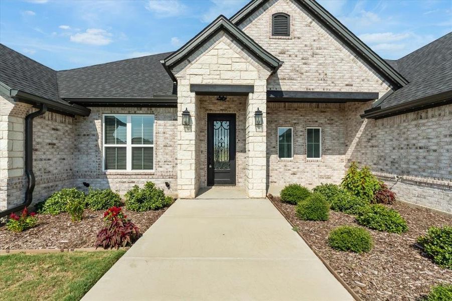 Front exterior of a new home in , Weatherford, TX, highlighting curb appeal (Image 17).