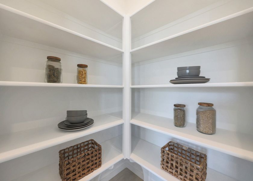 A white shelving unit with baskets and baskets.