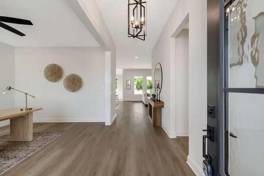 Foyer entrance featuring dark wood-type flooring, a chandelier, and recessed lighting Foyer entrance featuring dark wood-type flooring, a chandelier, and recessed lighting
