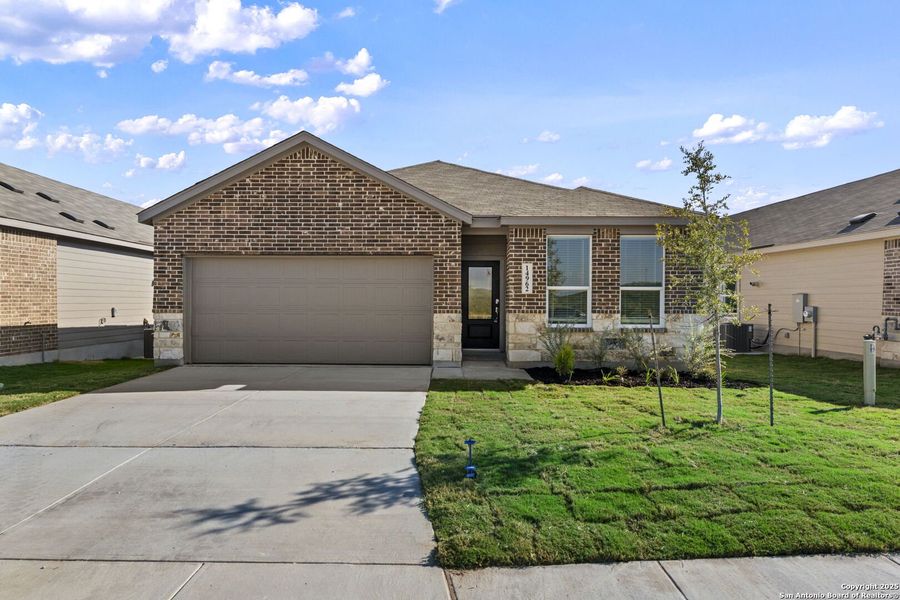 Front exterior of a new home in Waterwheel: Coastline Collection, San Antonio, TX, highlighting curb appeal (Image 1).