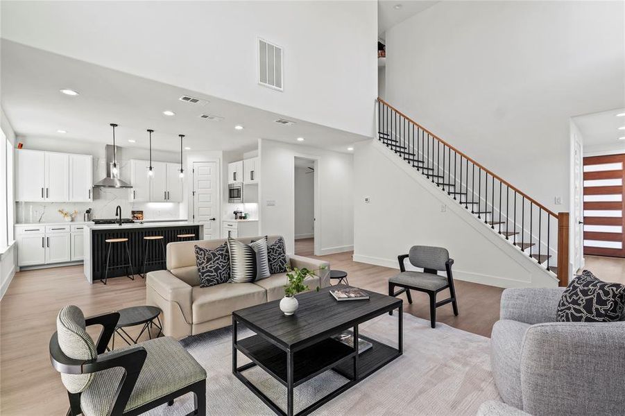 Living room with light hardwood / wood-style flooring and sink