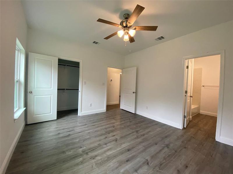Primary bedroom featuring dark wood finished floors, a closet, and ceiling fan Primary bedroom featuring dark wood finished floors, a closet, and ceiling fan