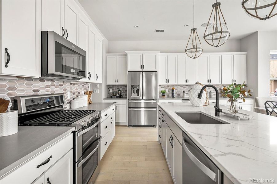 Double oven and five-burner gas range, ample cabinet space Double oven and five-burner gas range, ample cabinet space