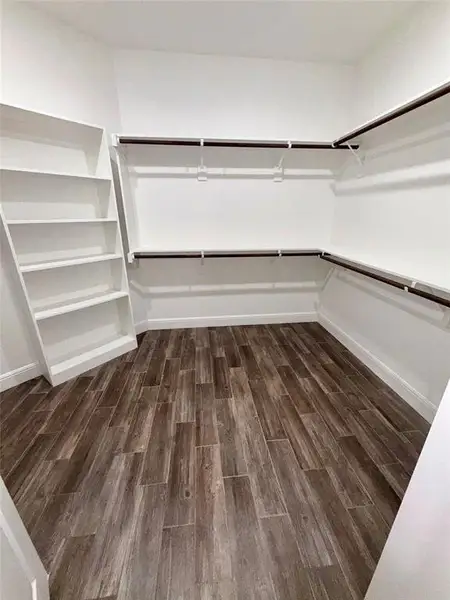 Primary bedroom ensuite, walk in closet with custom closet system.