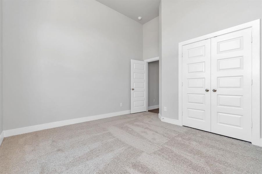 generously sized secondary bedrooms, plush carpeting underfoot, and ample natural light flooding through the large windows. With spacious closets to accommodate all your storage needs, this bedroom offers comfort and functionality in equal measure. Sample photo of completed home. Actual colors and selections may vary.