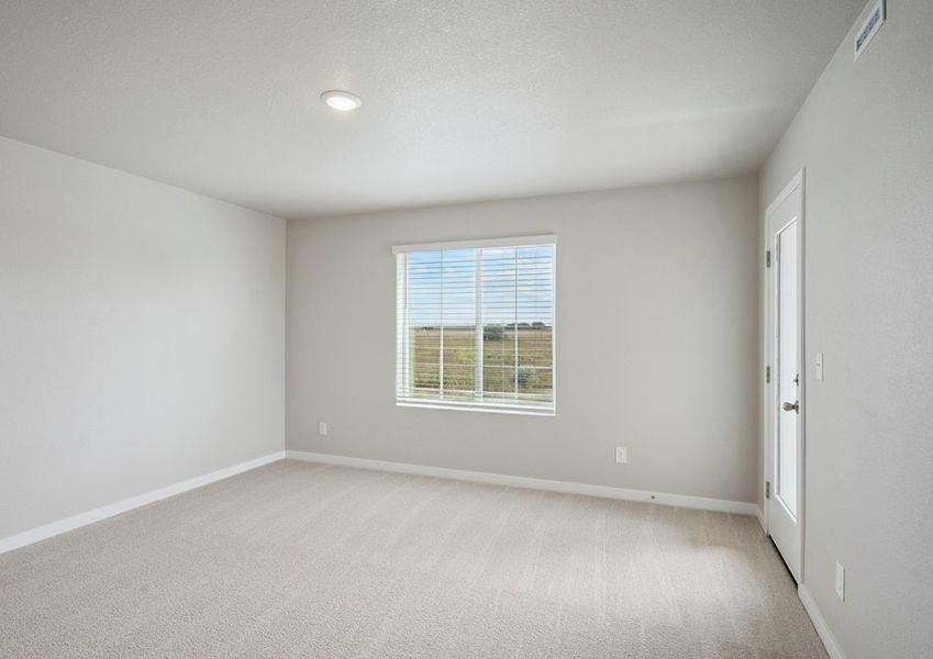 The master bedroom is spacious and has access to a deck.