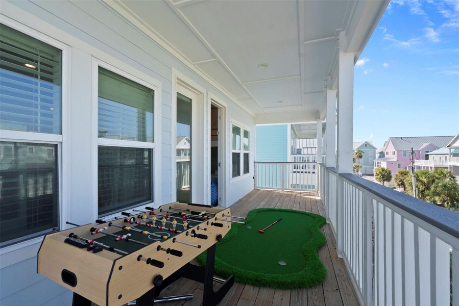 Step right out from the family bedrooms onto this spacious front balcony—an elevated retreat designed for both relaxation and recreation. With foosball and a mini putting green, it seamlessly blends indoor comfort with outdoor fun. Step right out from the family bedrooms onto this spacious front balcony—an elevated retreat designed for both relaxation and recreation. With foosball and a mini putting green, it seamlessly blends indoor comfort with outdoor fun.