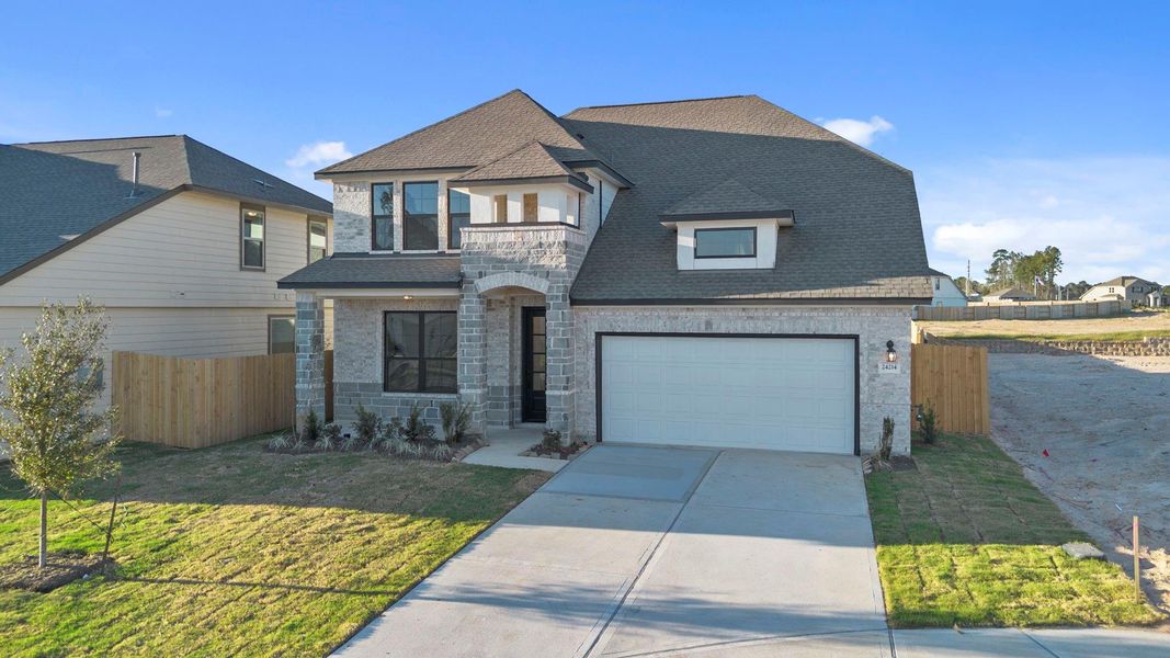 Front exterior of a new home in Spring Creek Trails, Magnolia, TX, highlighting curb appeal (Image 23).