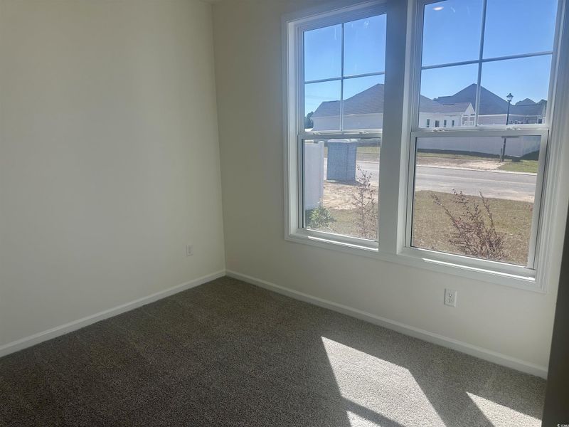 Carpeted empty room with baseboards