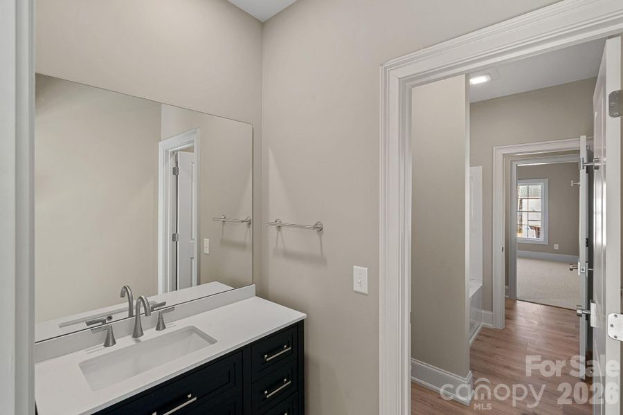 Shared between two secondary bedrooms, this "Jack-and-Jill" bath features individual vanities on each side for added convenience.