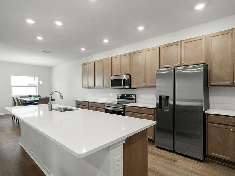 Dine at the island, or in the adjacent cafe - Everly by Highland Homes