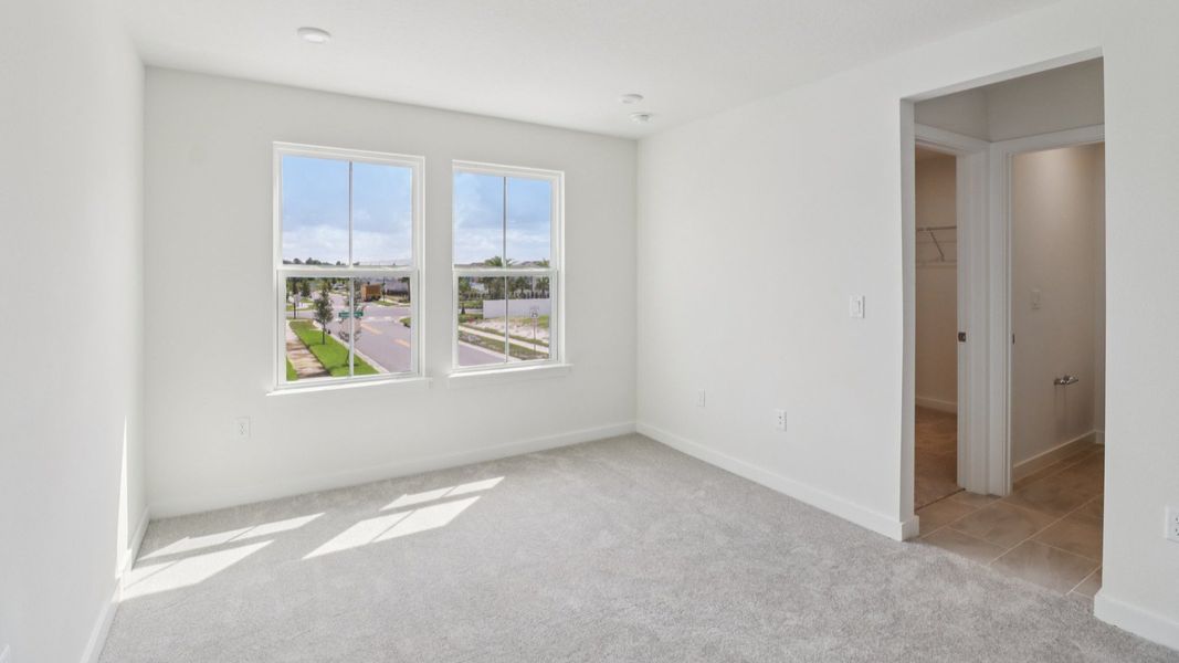 Primary Suite with en suite bath with dual sinks in the Monterey End Townhome by DRB Homes - Cyrene at Harmony in St Cloud FL