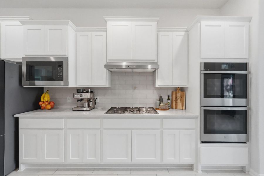 Clean, modern kitchen with white cabinetry, and sleek finishes.