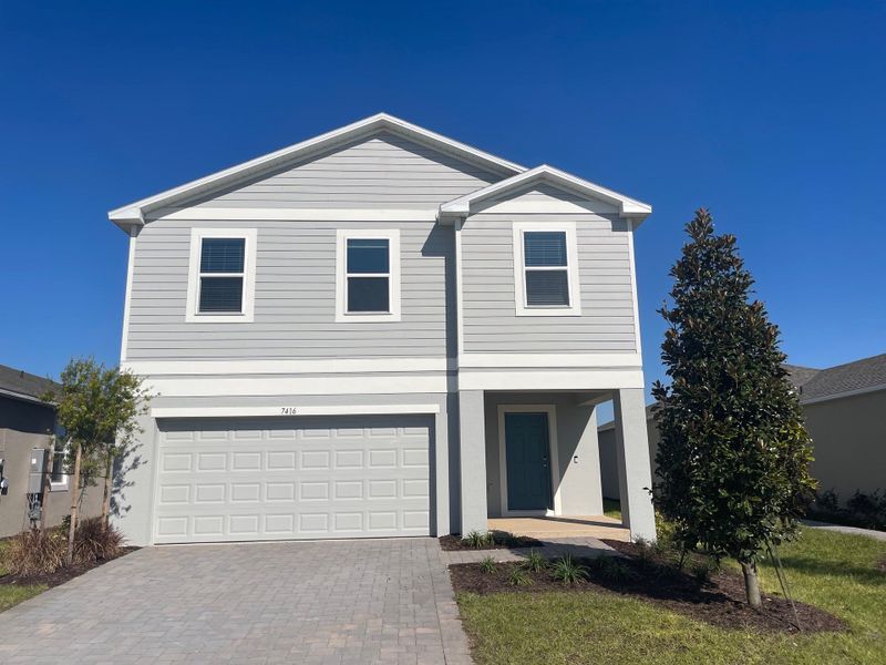 Front exterior of a new home in Waterstone, Groveland, FL, highlighting curb appeal (Image 1). Front exterior of a new home in Waterstone, Groveland, FL, highlighting curb appeal (Image 1).