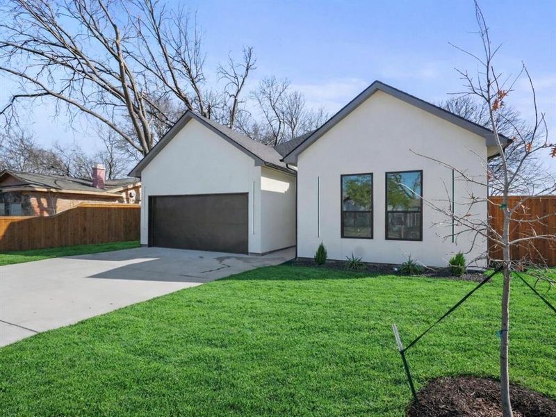 View of front of house featuring driveway, stucco siding, and a garage View of front of house featuring driveway, stucco siding, and a garage