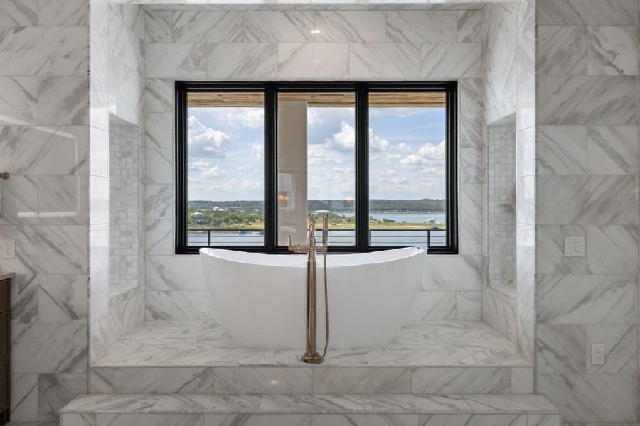 Indulge in a relaxing soak with sweeping lake views from this lavish primary bathroom. Indulge in a relaxing soak with sweeping lake views from this lavish primary bathroom.