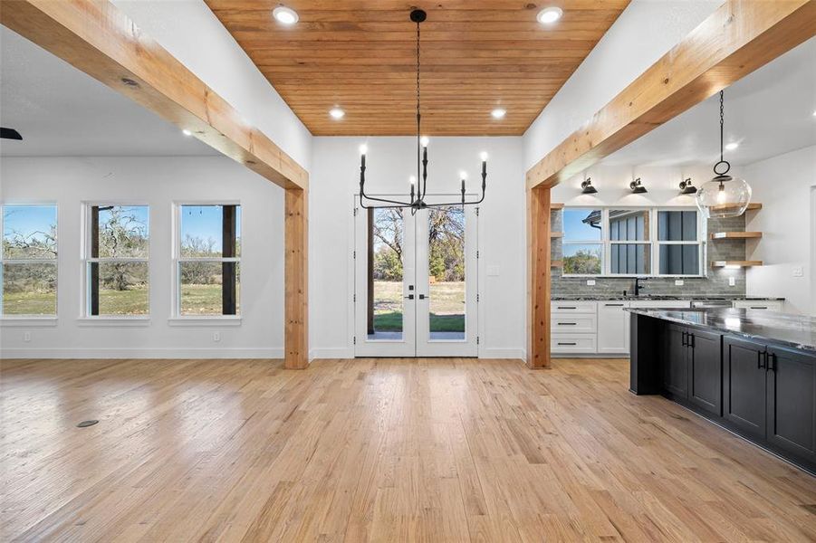 Kitchen with pendant lighting, a healthy amount of sunlight, and light hardwood / wood-style flooring