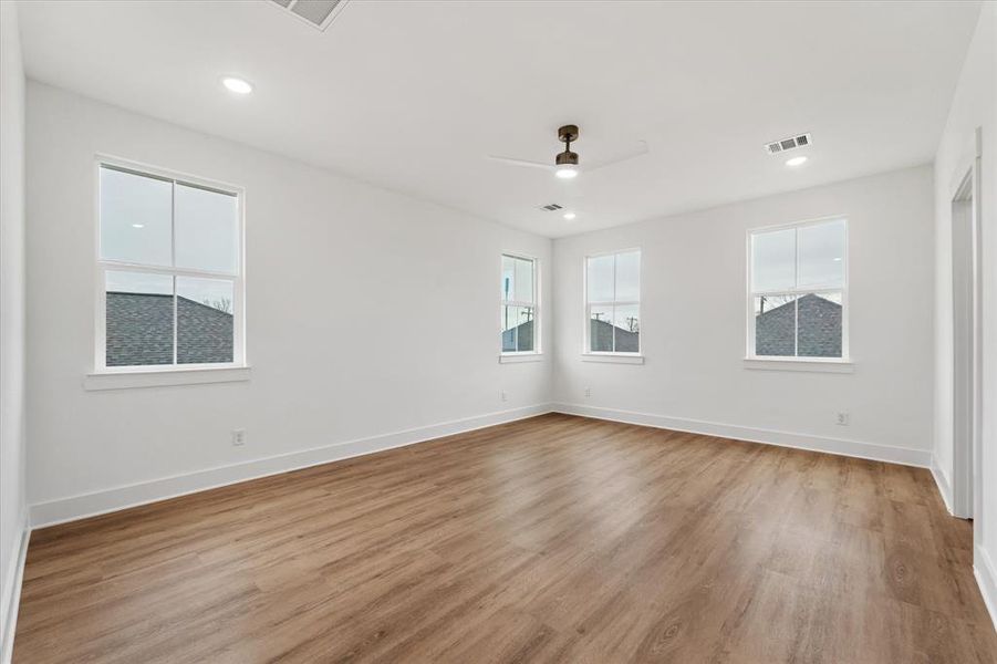 Your ample primary bedroom is bathed in natural light and enhanced by recessed lighting. The luxury vinyl flooring brings the perfect balance of elegance and practicality to this ever-so crucial space.