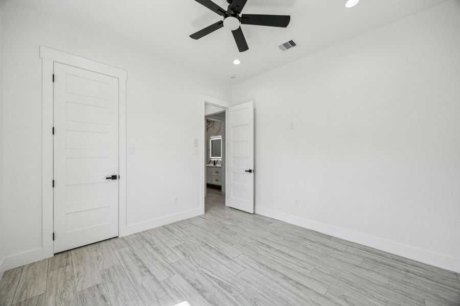 all secondary bedrooms feature a ceiling fan for added comfort and the 10-foot ceilings. Notice the 8 foot custom doors that are present throughout the home. all secondary bedrooms feature a ceiling fan for added comfort and the 10-foot ceilings. Notice the 8 foot custom doors that are present throughout the home.