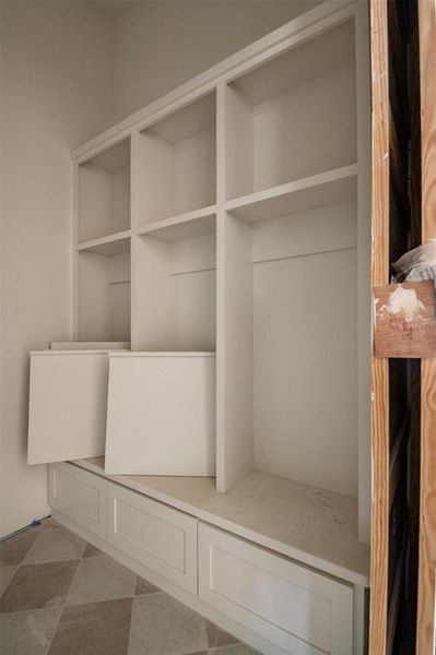 Custom mud room with bench and lockers as you come inside from the garage.