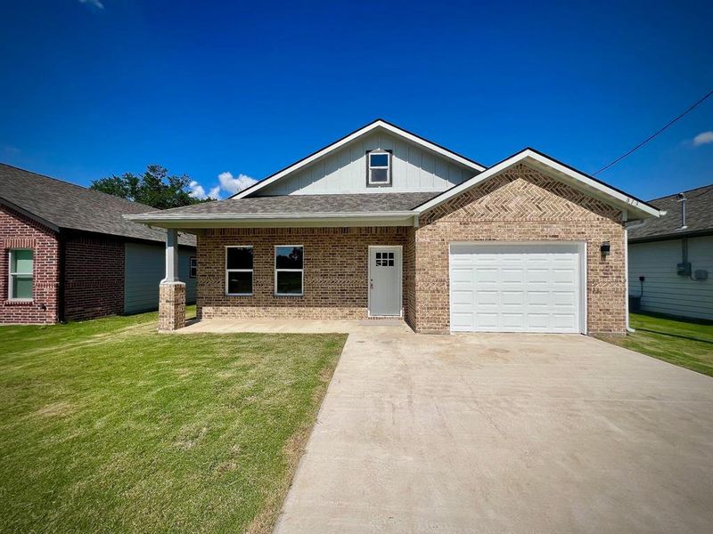 Front exterior of a new home in , Greenville, TX, highlighting curb appeal (Image 2). Front exterior of a new home in , Greenville, TX, highlighting curb appeal (Image 2).