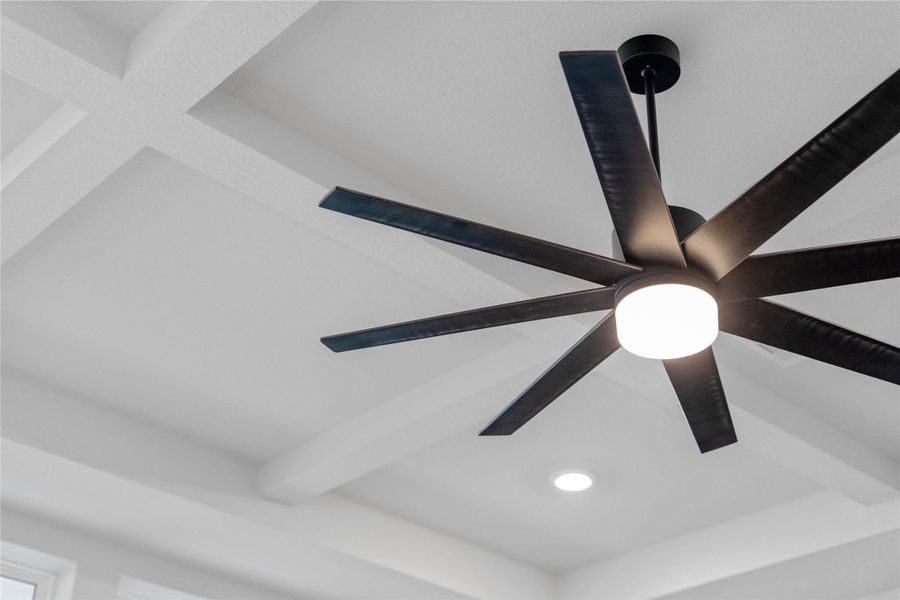 Sophisticated, deep-grooved coffered ceiling adding dramatic texture and dimension. The matte black multi-blade ceiling fan features integrated LED lighting and comfort all year round.