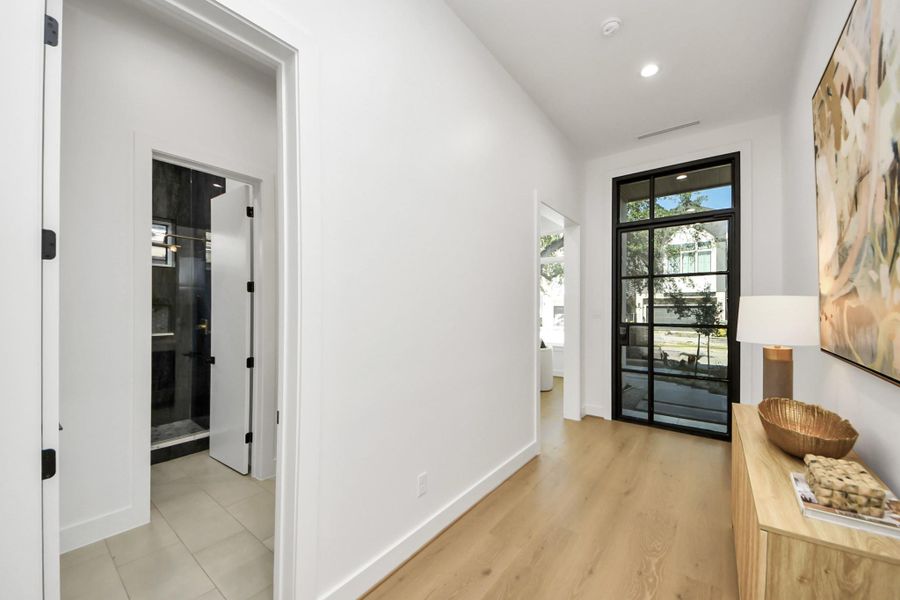 Convenient downstairs full bath with a sleek standing shower, offering flexible use as a powder bath.