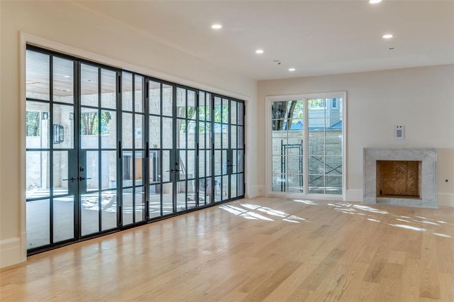 Unfurnished living room featuring a fireplace and light hardwood / wood-style flooring