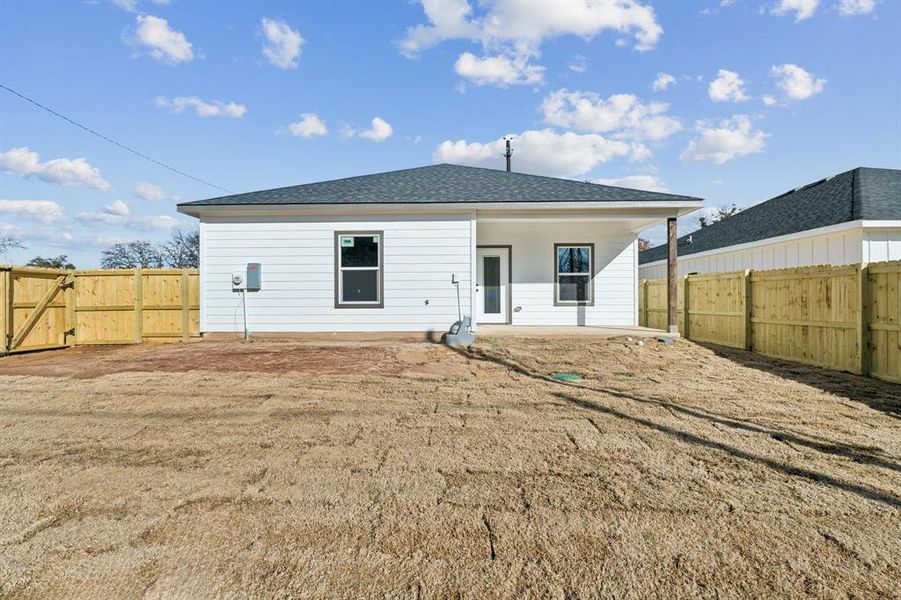 Back of house featuring a patio and a lawn