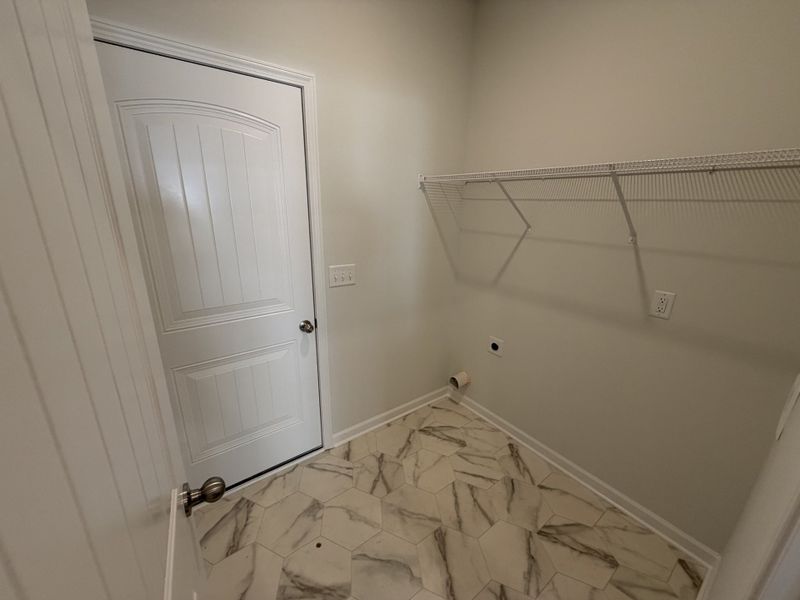 Laundry Room sits between the garage and kitchen. It features the easy clean vinyl flooring and even an additional linen closet/second pantry!